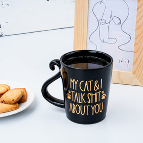 Hendson gold graphic mug shines on kitchen shelf.