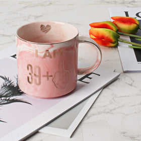Hendson pink marbled mug with golden accents enhances desk or kitchen space