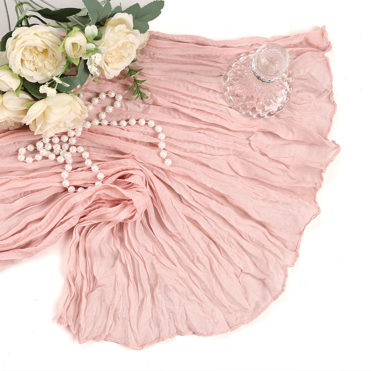 Heneger draped backdrop and seating setup with blush pink cheesecloth.