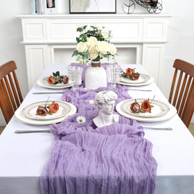 Heneger lilac cheesecloth table runner draped from ceiling for a dreamy effect.