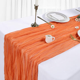 Wedding table setup with Heneger orange cheesecloth runner for romantic decor