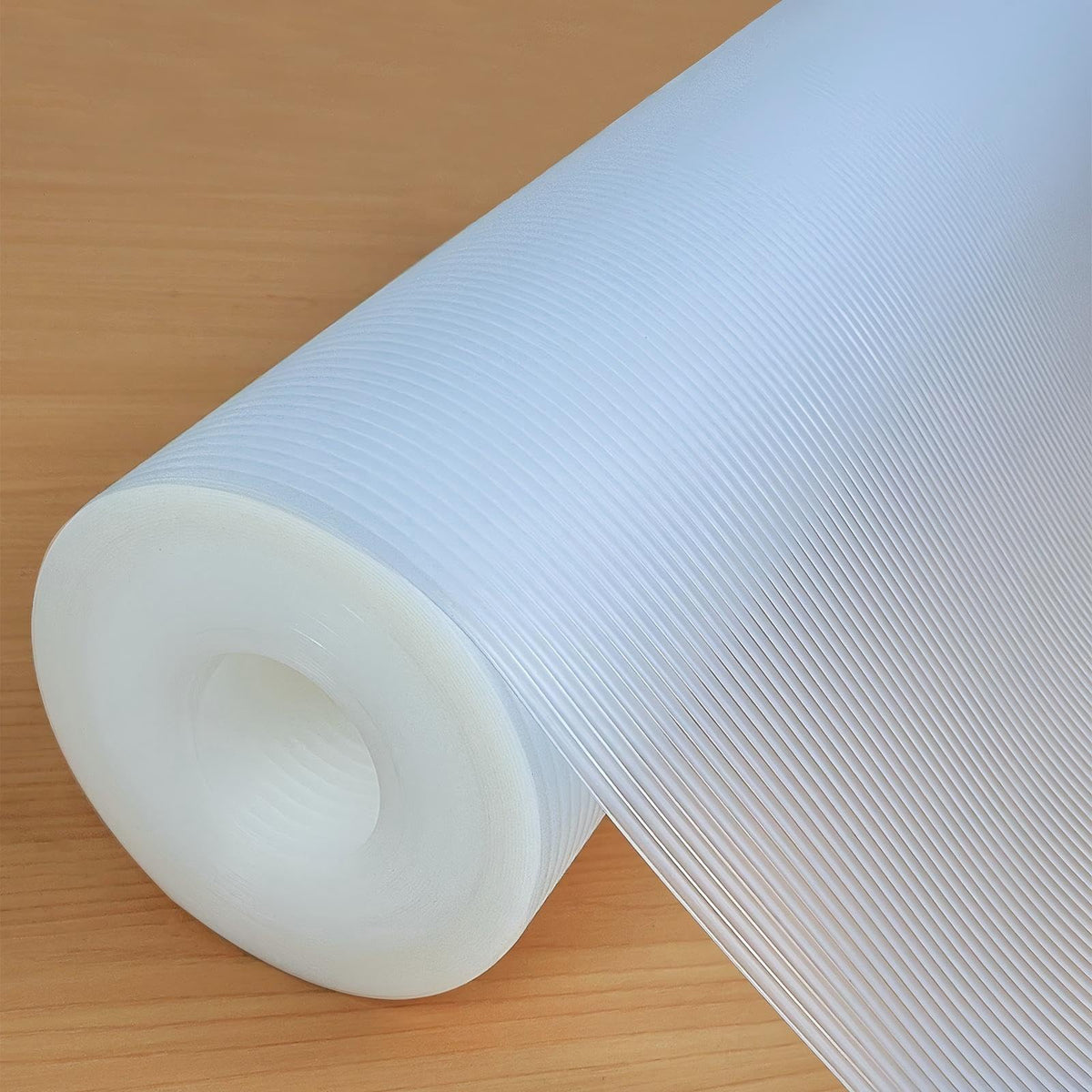 Hersvin shelf liner in clear stripe protecting a cabinet shelf and keeping contents organized.