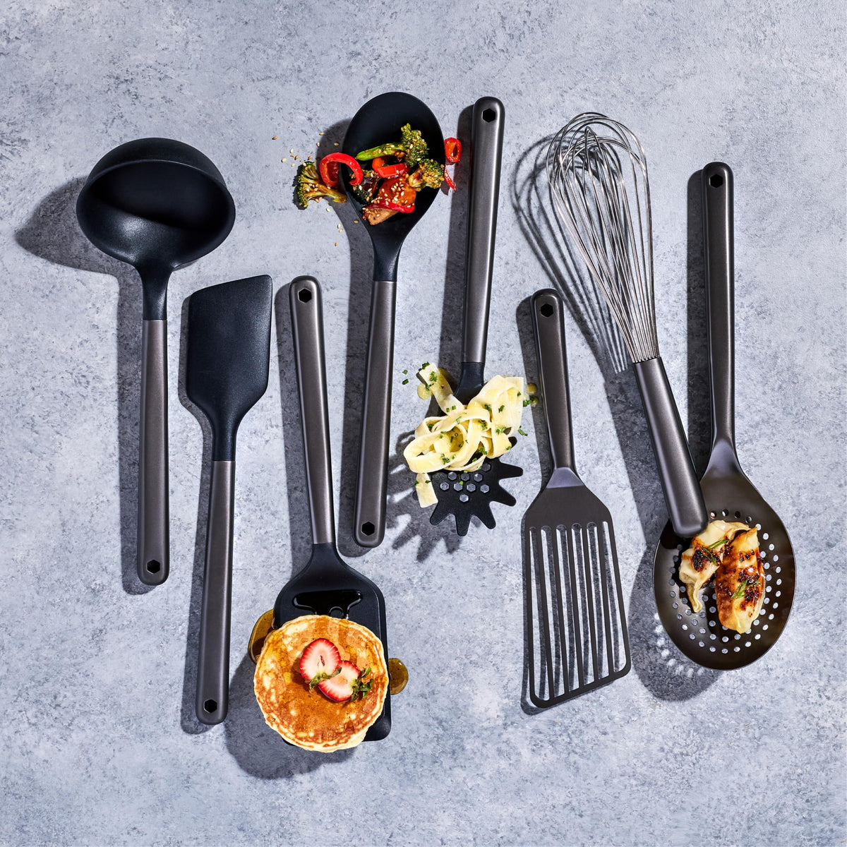 HexClad spoon in gunmetal finish for versatile stirring.