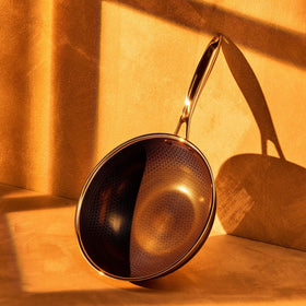 HexClad Hybrid 10-inch Wok side view highlighting depth for sautéing.