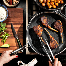 HexClad Hybrid 12-inch pan sizzling vegetables for a quick sear