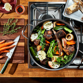 HexClad Hybrid 12QT stockpot with glass lid monitors simmer while retaining moisture.