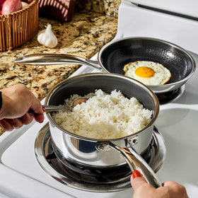 HexClad Hybrid 2-Quart Saucepan with lid on, perfect for simmering grains.