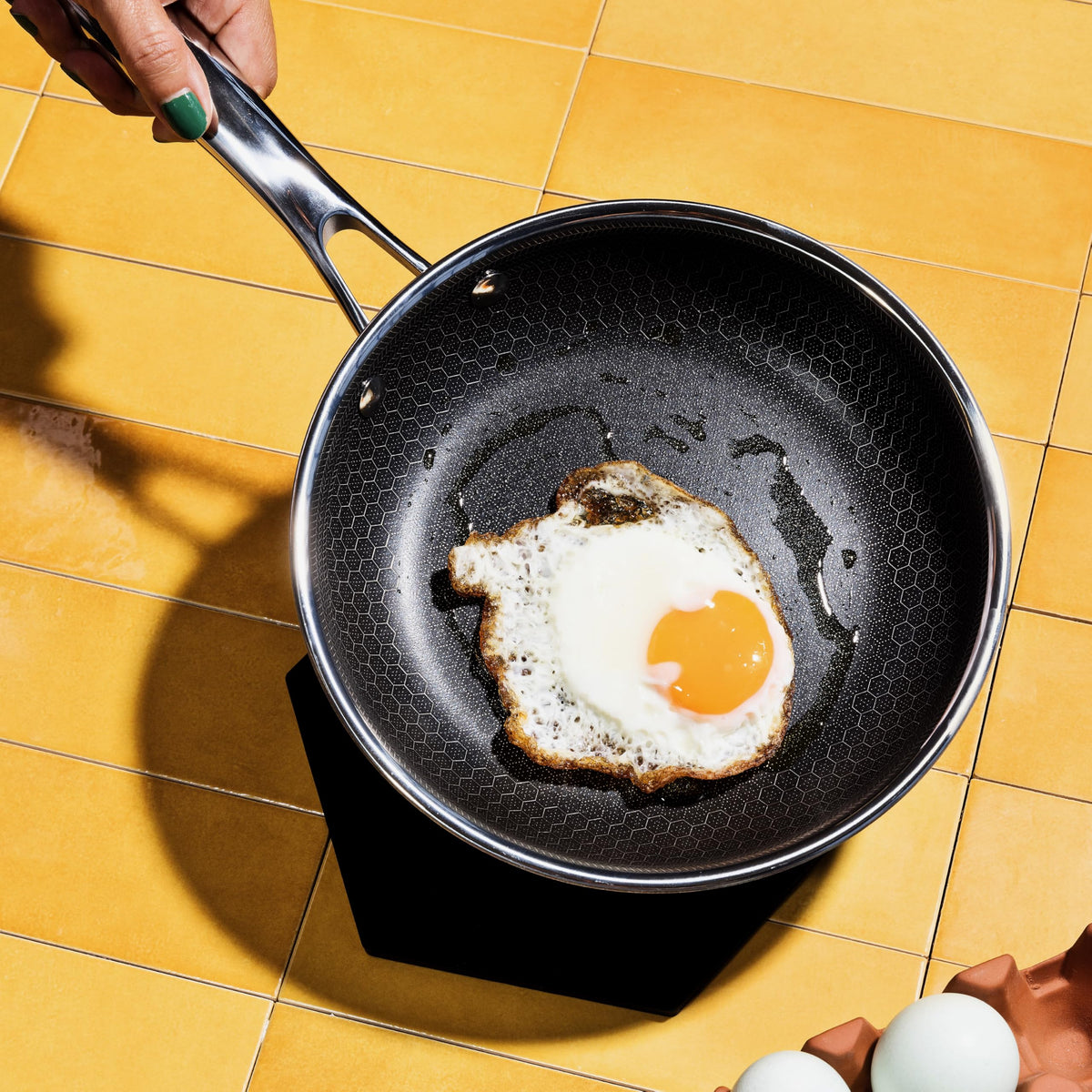 HexClad Hybrid 7-Inch pan on induction cooktop delivering even heating.