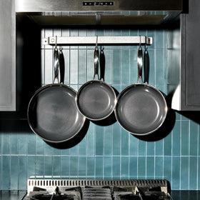 HexClad 10-inch pan providing even heat for sautéing vegetables.