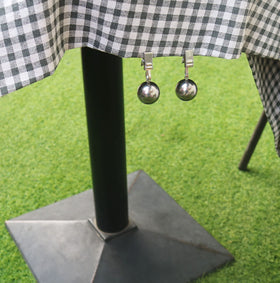 HillSpring weights shown securing an outdoor table cover against wind.