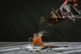 Close-up of HIWARE teapot lid and glass showing premium finish