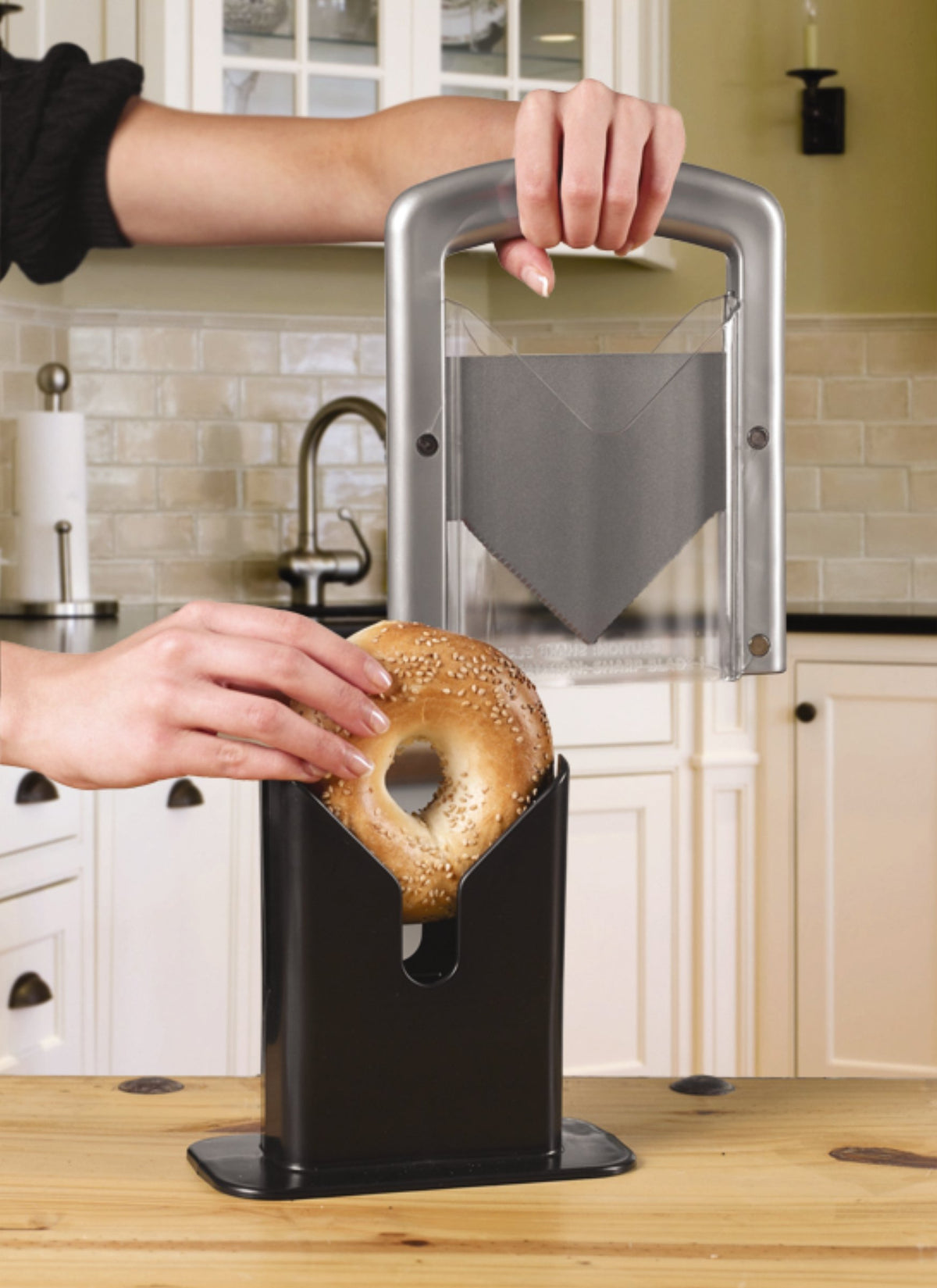 Hoan Bagel Biter showing two safety shields protecting fingers during use.