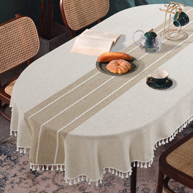 HOMBYS oval tablecloth with tassels adds elegant embroidery to the dining table.
