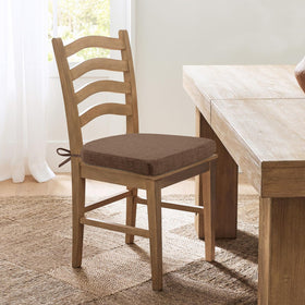 HOMELYSIAN brown cushions add warm style to dining area.
