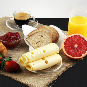 Homing camping table setup with tablecloth for outdoor meals.