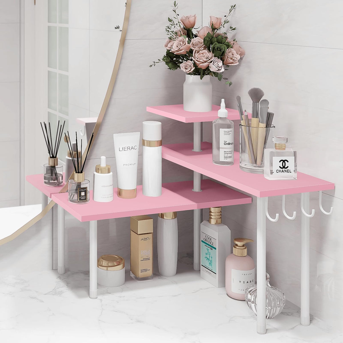 Homode pink 3-tier organizer on dresser for makeup and cosmetics organization.