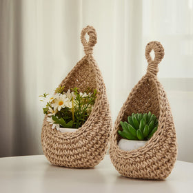 Honeydak boho hanging wall baskets displaying flowers and small plants on wall.