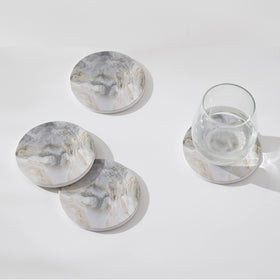 Hoomey cork-backed coasters prevent scratches on wooden surfaces when used.
