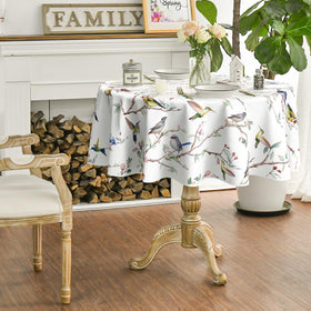 Horaldaily 90x90 round tablecloth on table showcasing birds-branch-white-floral motif.