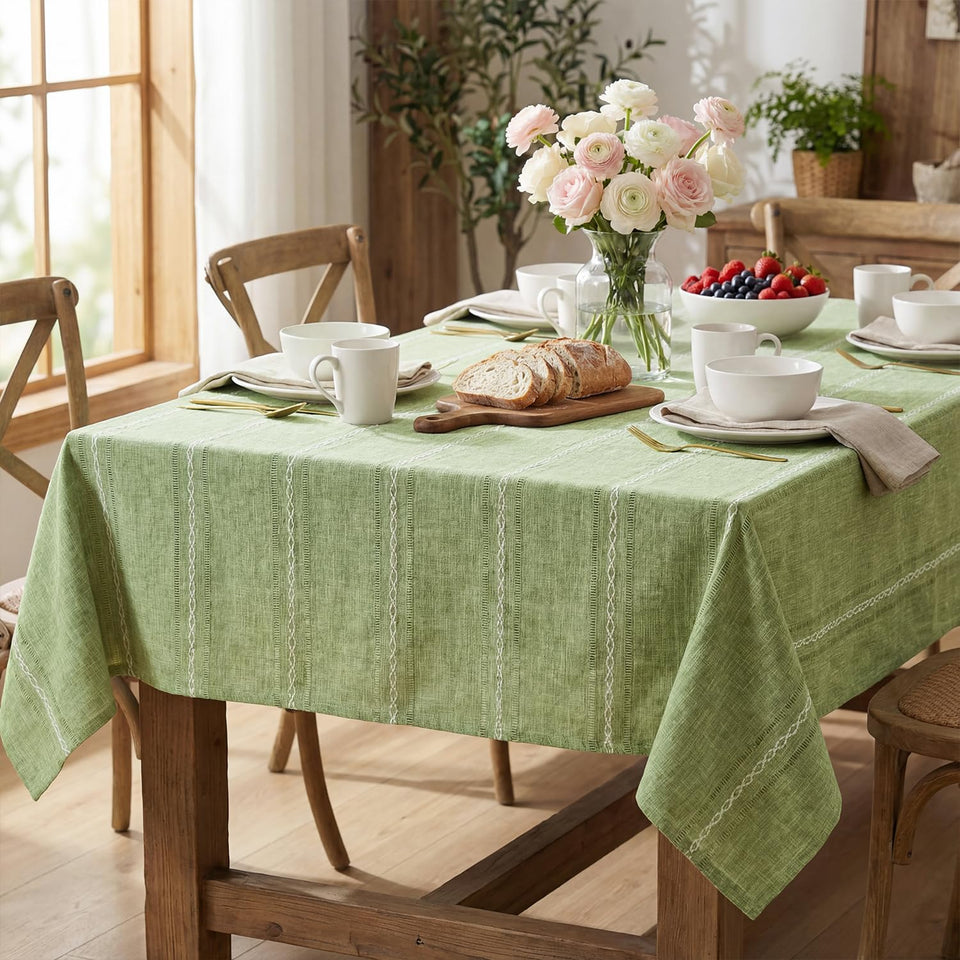 Horaldaily Sage Green Tablecloth 60x84 in on a rectangular table, showcasing rustic elegance and surface protection
