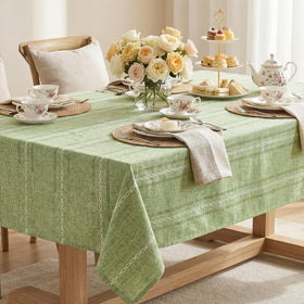 Horaldaily Sage Green Tablecloth set on a dining table, creating an inviting scene
