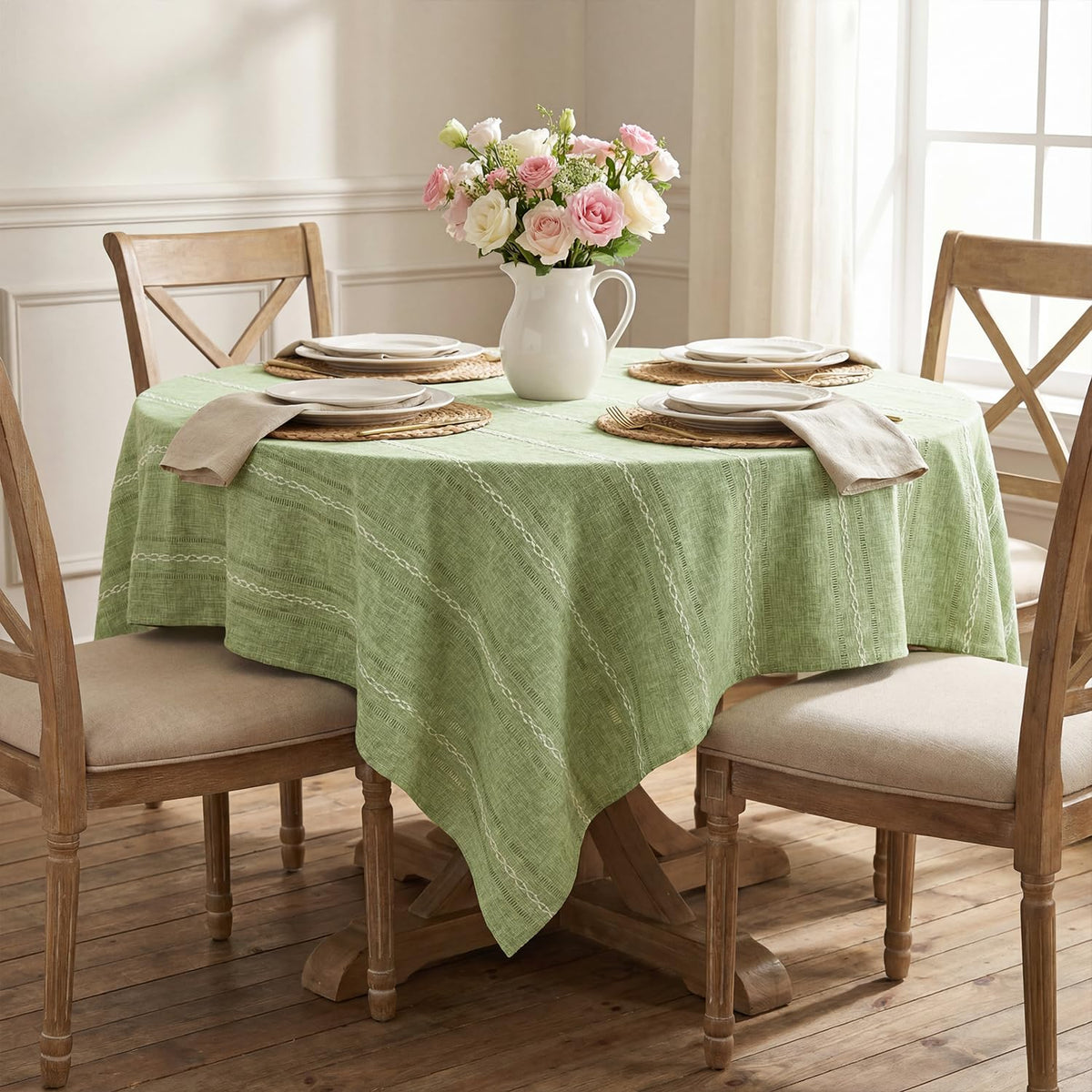 Close-up of Horaldaily hemstitched embroidery on sage green tablecloth for refined detail