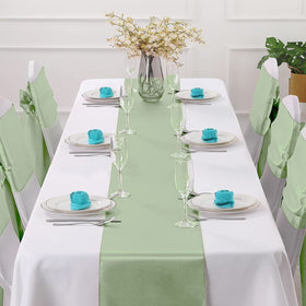 Horbaunal sage green satin runner draped on a table for wedding ambiance and shine.