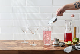 Houdini 24oz glass cocktail shaker hand-wash scene emphasizes easy cleaning.