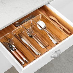 See-through plastic storage bin shown inside a drawer for easy access
