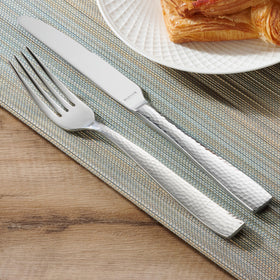 Hudson Essentials hammered flatware on dining table; cohesive look with various tableware.