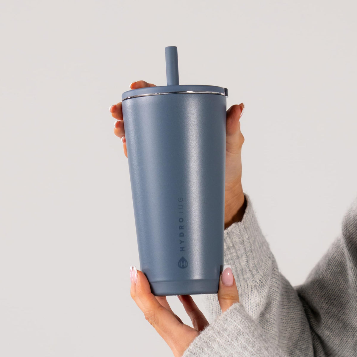 HydroJug's slim base fits most cup holders for travel stability.
