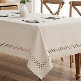 MIULEE beige rectangle tablecloth with decorative cutouts enhances rustic dining ambiance.
