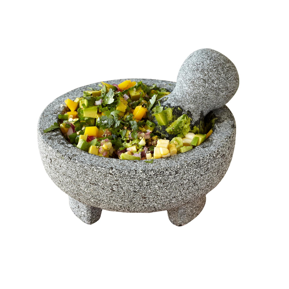 Imusa granite molcajete 8-inch in use for versatile grinding.