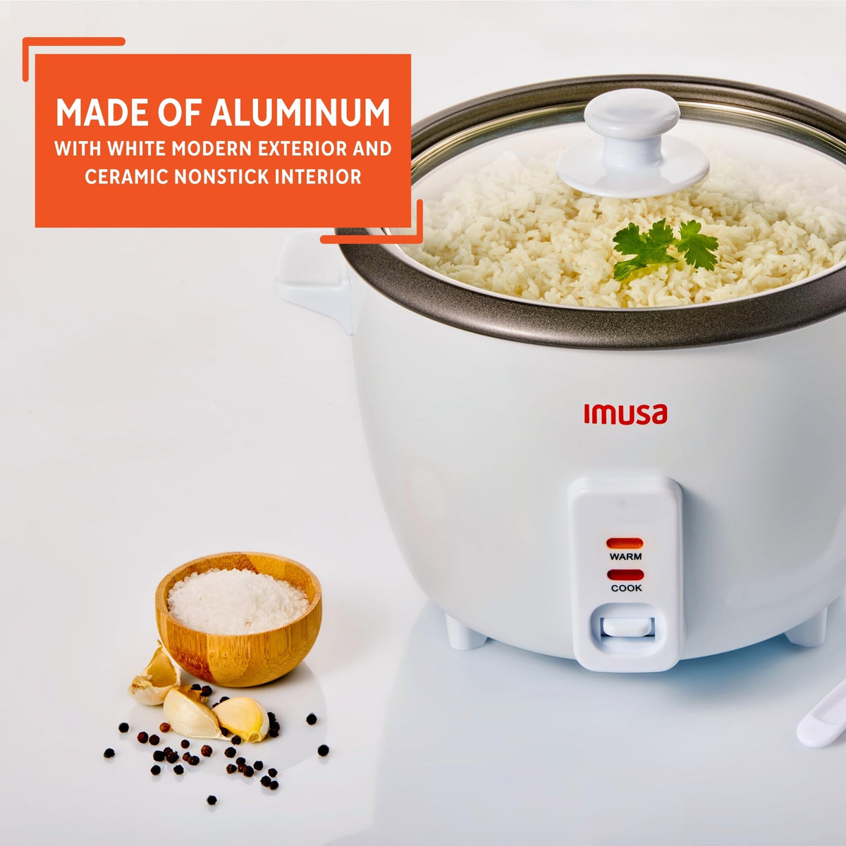 Imusa rice cooker with transparent lid for monitoring cooking progress.