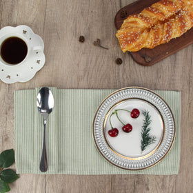 INFEI green striped napkins arranged in restaurant-style table setting