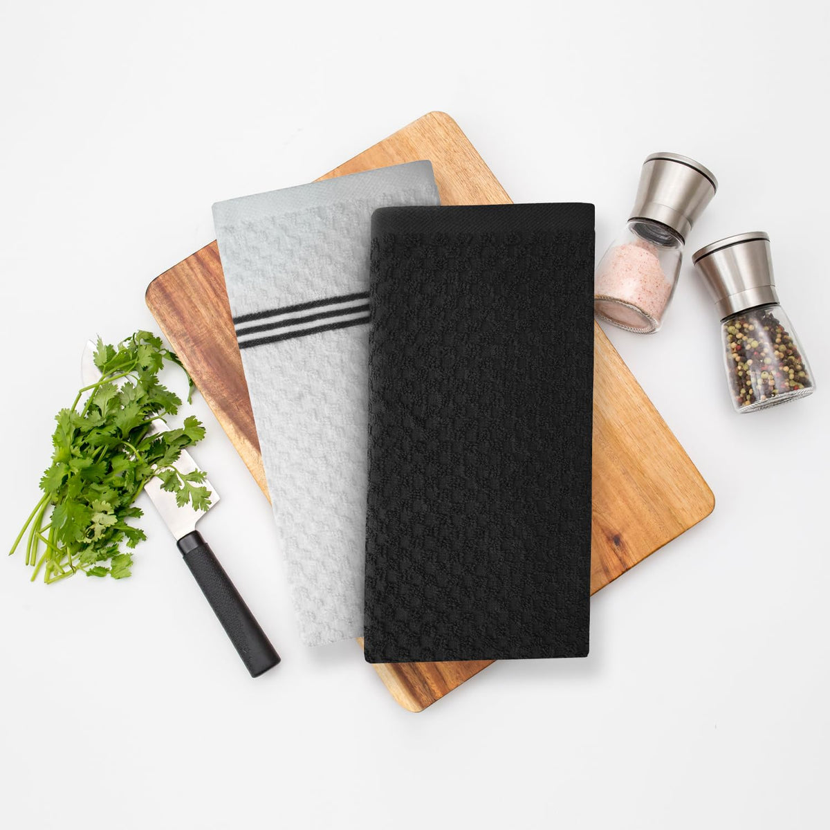 Infinitee Xclusives storm black kitchen towels in display ready to elevate linen sets.