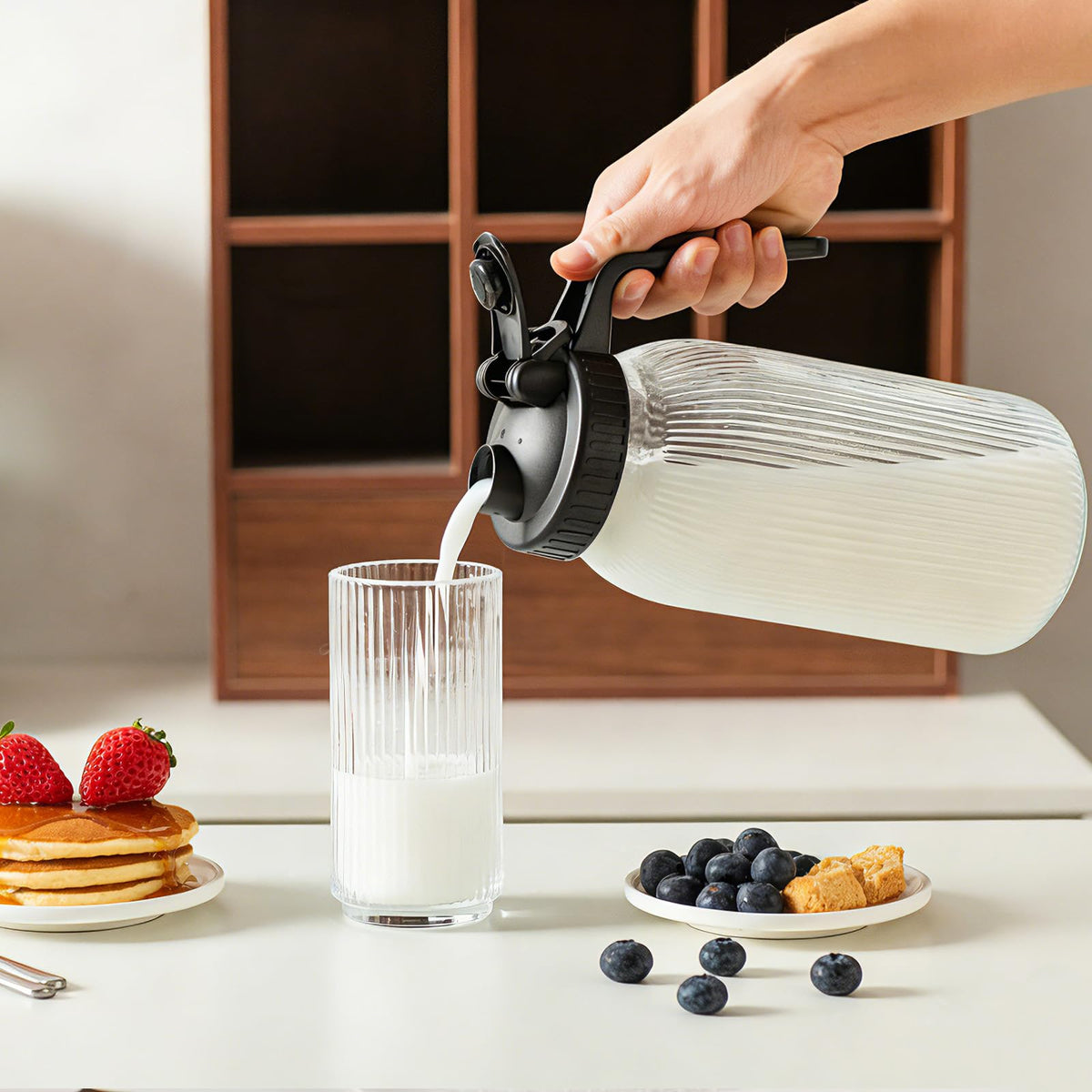 INSETLAN wide-mouth glass pitcher ideal for adding ice and flavor-infusing ingredients.