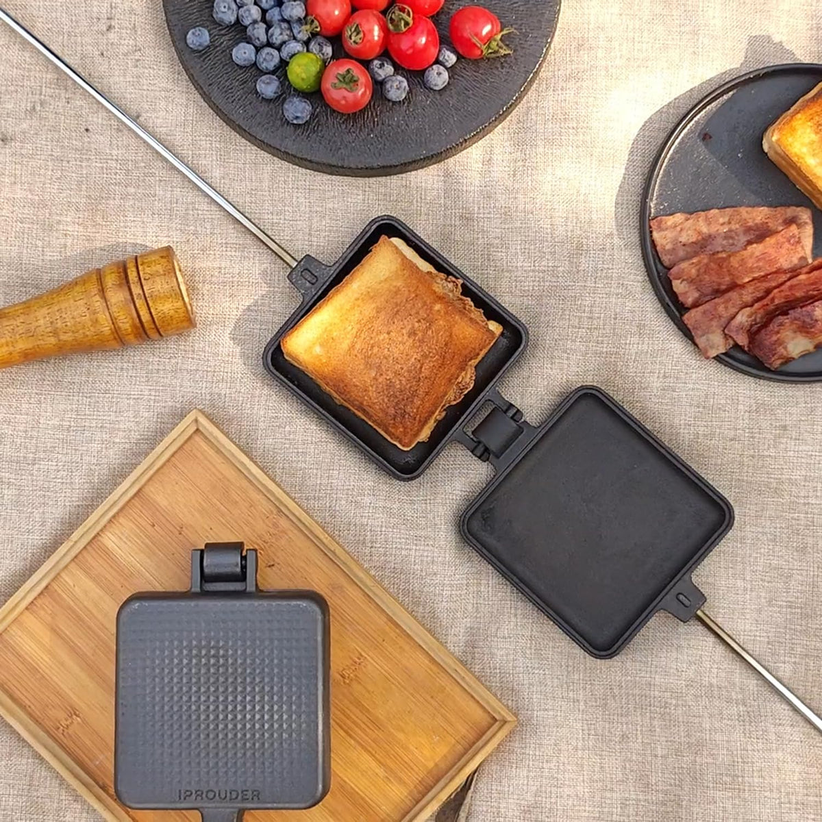 IPROUDER campfire pie iron on fire with two-piece set for versatile outdoor cooking.