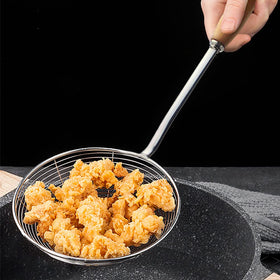 IQCWOOD spider strainer draining hot oil after frying potatoes.