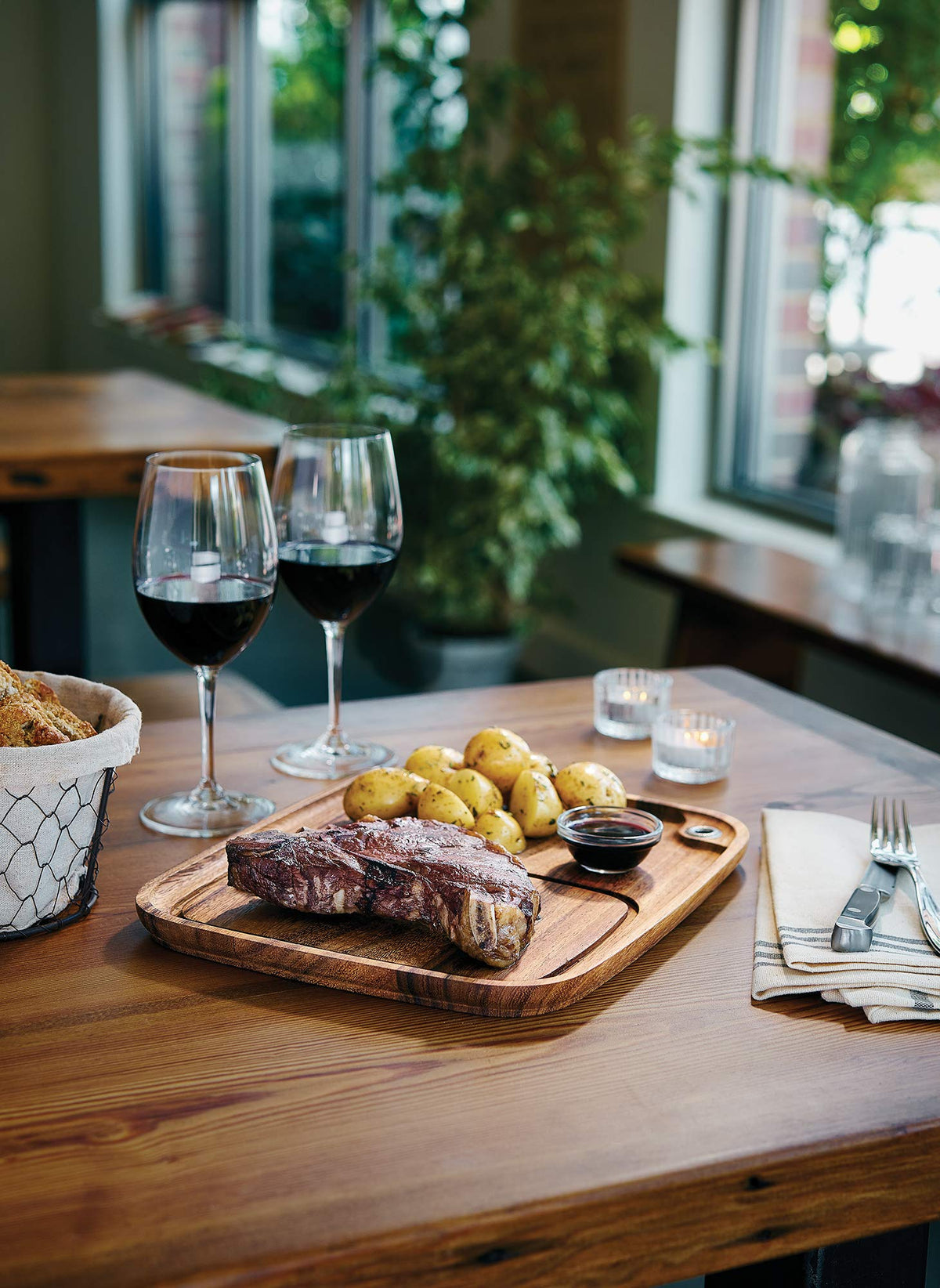 Ironwood Gourmet acacia wood plate grain detail enhances rustic table setting.