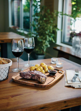 Ironwood Gourmet acacia wood plate grain detail enhances rustic table setting.