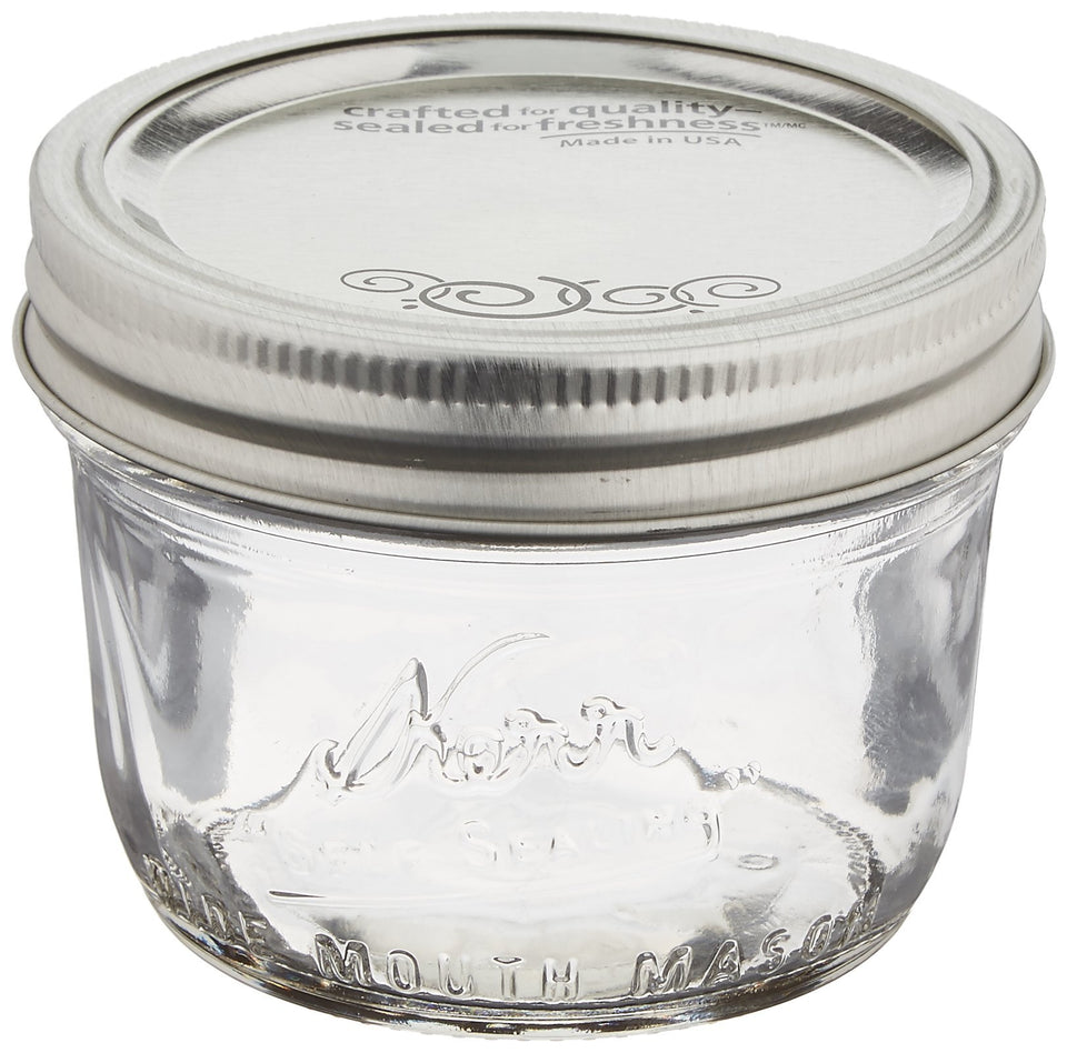 Jarden Kerr wide-mouth half-pint jar with lids and bands for fresh preservation and storage.