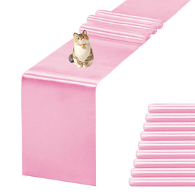 Jevix pink satin table runner draped on a dining table for elegant meals