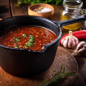 Jim Beam JB0204 basting pot on grill shows depth for ample sauce portions