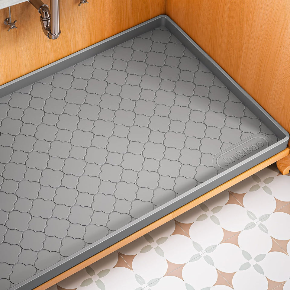 Jin&Bao under-sink mat 22x19 side view protects cabinets from leaks.