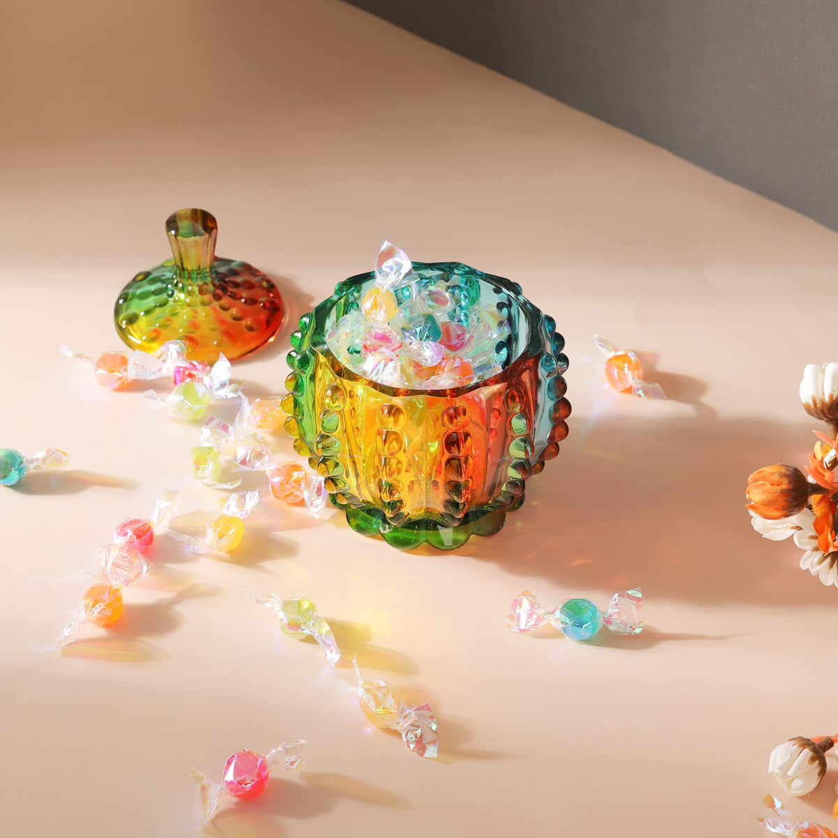 Joeyan iridescent glass jar filled with candies on a shelf.