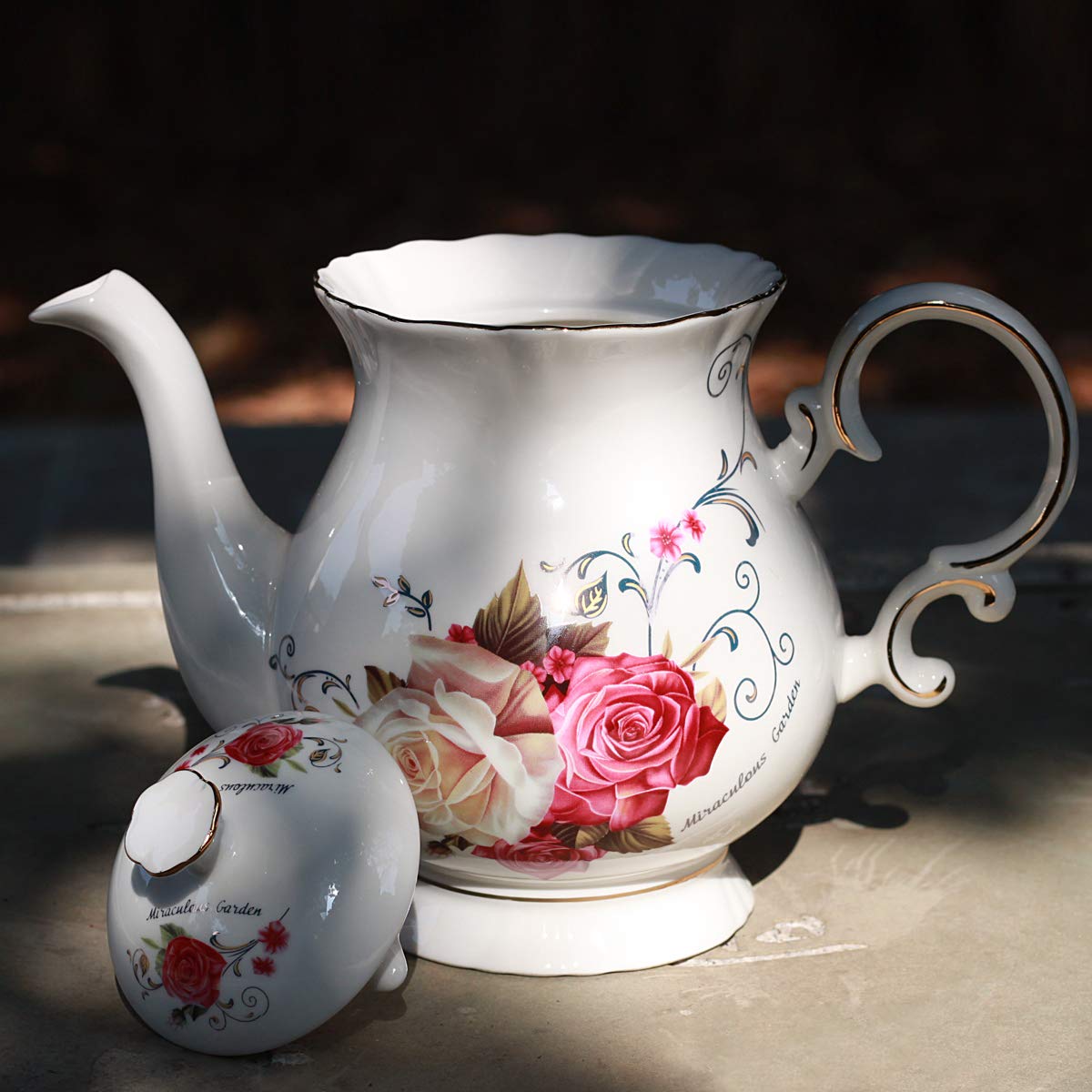 Porcelain hand-painted teapot by Jomop with gold trim adds a luxurious touch to gatherings.