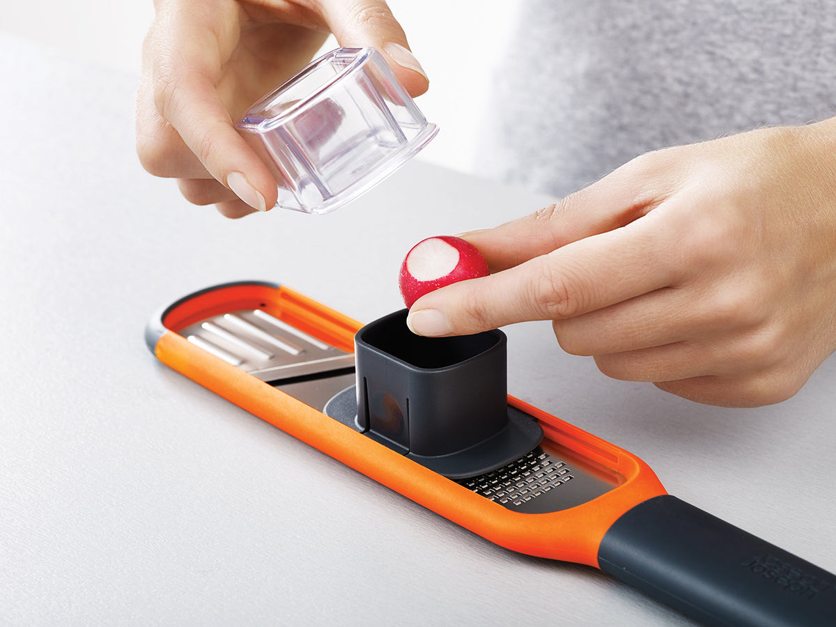 Joseph Joseph 2-in-1 Mini Grater & Slicer dishwasher safe for easy cleanup.