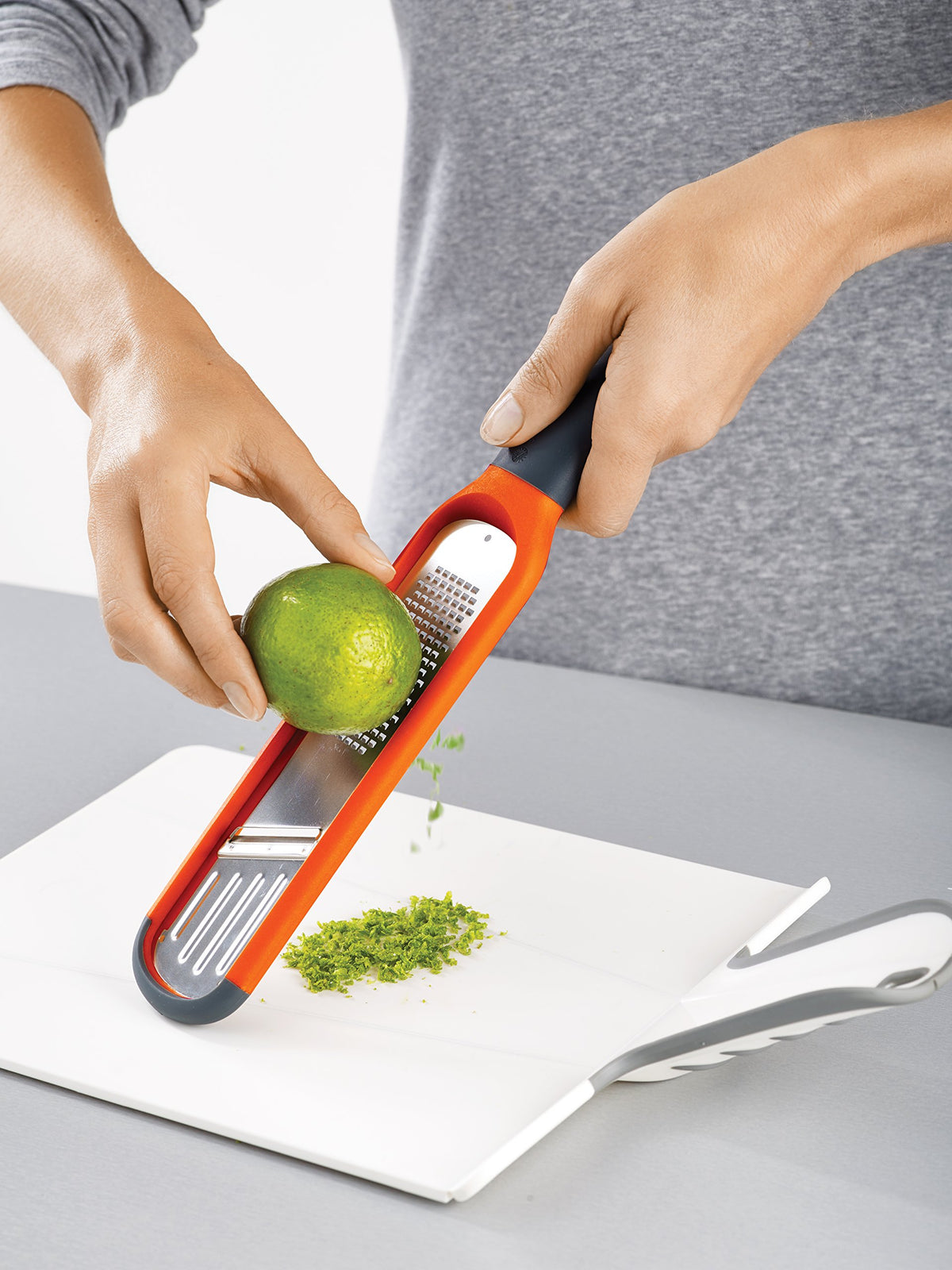 Joseph Joseph 2-in-1 Mini Grater & Slicer finger guard adds safety when slicing.