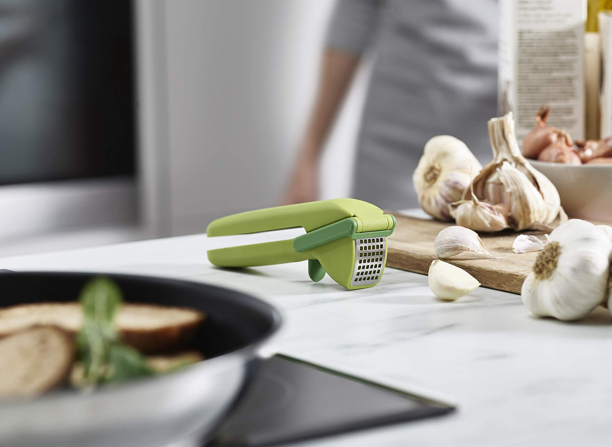 Joseph Joseph CleanForce garlic press compact storage keeps the cleaning tool tucked inside